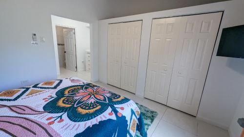 a bedroom with two white closets and a bed at MoBay Las Palmas in Montego Bay