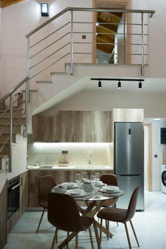 a kitchen with a table and chairs and a refrigerator at Zante way villas in Alikanas