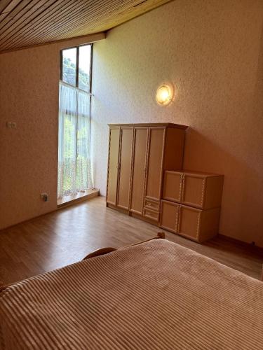 an empty room with a bed and a window at Alpina Guest House in Yeghegis