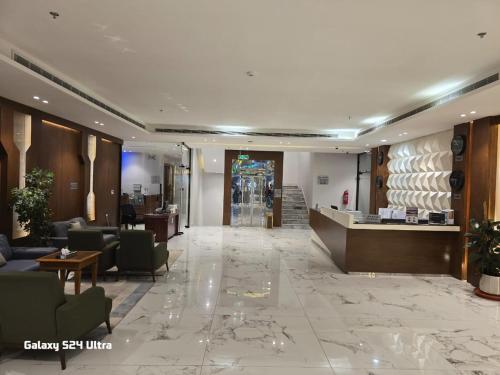 a lobby of a hotel with couches and a counter at Namar Home Serviced Apartment - Tuwaiq  in Riyadh