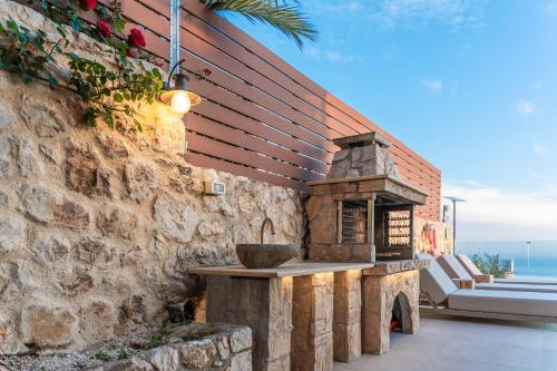 a stone oven on the side of a stone wall at Kefalonia Heaven Villa in Vlachata