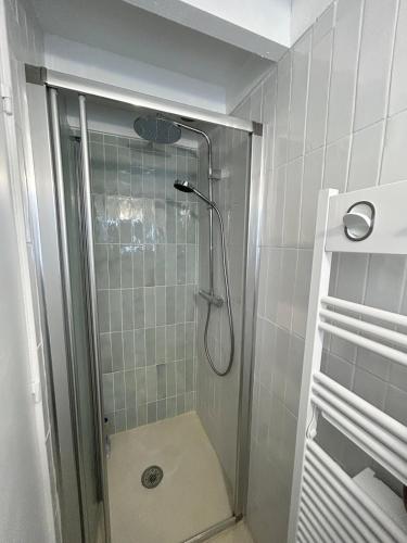 une douche avec une porte vitrée dans une salle de bain dans l'établissement SLOW - Hossegor, océan & lac à pieds, à Capbreton