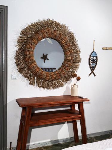 a wreath hanging on a wall with a wooden table at The Traditional Stone Villa in Koundouros
