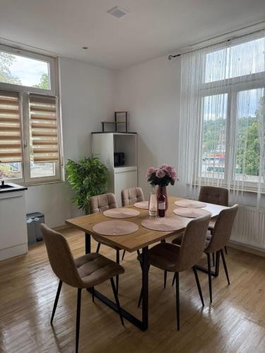a dining room with a wooden table and chairs at Schickes Apartment am Rhein mit Rheinblick 4 in Koblenz