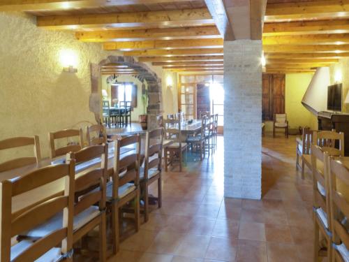 a dining room with wooden tables and chairs at Cottage in Maians with Sea View & Pool in Castellfullit del Boix