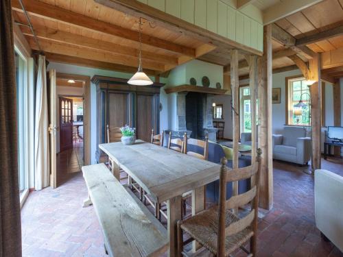 a dining room with a wooden table and chairs at Farmhouse in Enschede near Forest in Enschede