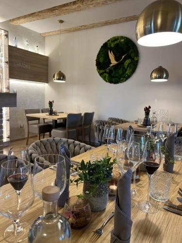 a long wooden table with wine glasses on it at U HRÁDKU Superior in Znojmo