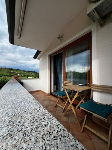 a balcony with a table and chairs and a window at Apartment Storia Romantica in Koper