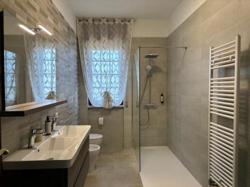 a bathroom with a shower and a sink and a toilet at Terrarossa in Crispiano