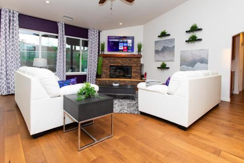a living room with two white couches and a fireplace at Amethyst Hearth - Family Spa Serenity, Zoo, Beach, Disneyland, Legoland in Vista