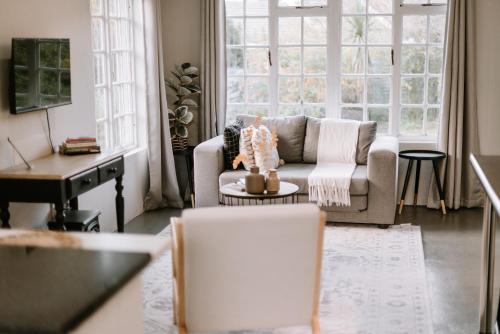 a living room with a couch and a table at Platteland Cottage in Clarens