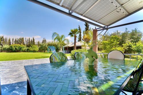a table with a green toy on top of it at Ferme de vacances avec une grande villa à Marrakech in Marrakech