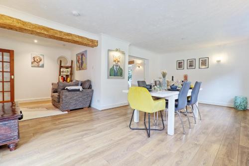 a dining room with a table and chairs at Luxury 4-Bed Family Home in Epping with Parking by LMV Property in Epping