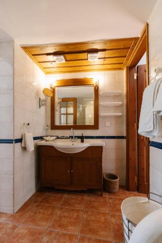a bathroom with a sink and a mirror at Marcela's house in Hydra