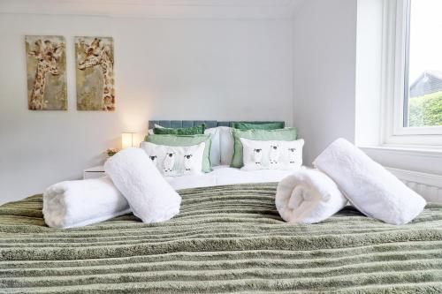 a bedroom with a white bed with white pillows at Luxury 4-Bed Family Home in Epping with Parking by LMV Property in Epping