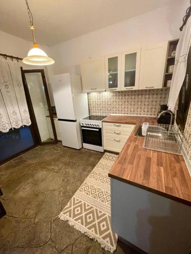 a kitchen with white cabinets and a counter top at Star Country House in Ormos Panagias
