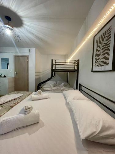 a bedroom with two beds with towels on them at Star Country House in Ormos Panagias