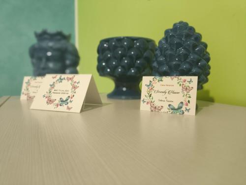 two boxes sitting on a table with black grapes at Light Blue Room in Scordia