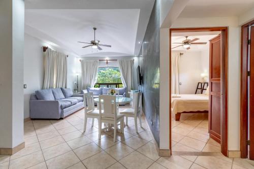 a living room with a table and a couch at The Oaks Tamarindo Pool Front Condominiums fast wifi in Tamarindo