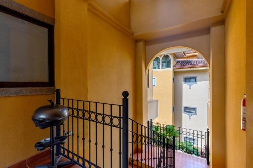 a hallway with an archway and a balcony at The Oaks Tamarindo Pool Front Condominiums fast wifi in Tamarindo