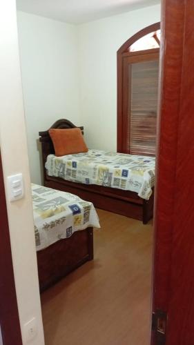 a bedroom with two beds and a mirror at Castelo da Lagoa in Lagoa Santa