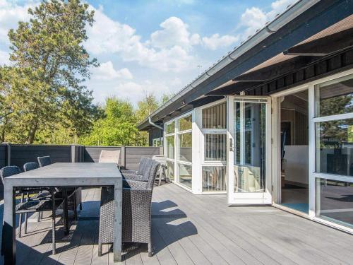 a patio with a table and chairs on a deck at 8 person holiday home in Ebeltoft-By Traum in Ebeltoft