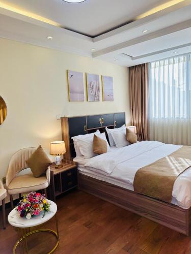 a hotel room with a bed and a chair at Calm Corner Addis in Addis Ababa