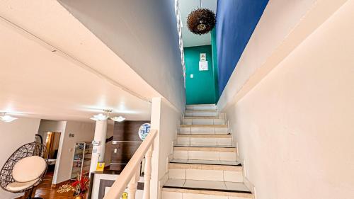 a staircase in a home with a blue wall at Hotel Santiago de Tolú in Santiago