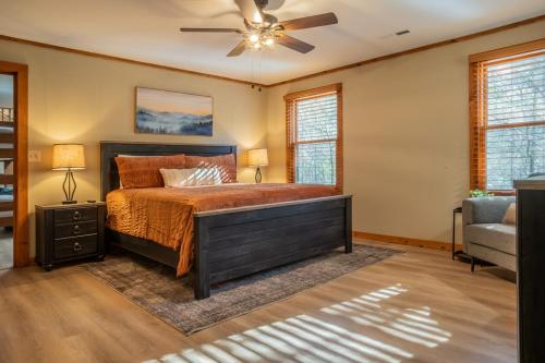 a bedroom with a bed and a ceiling fan at Mountain Log Cabin, Games, HotTub, Outdoor Firepit in Pigeon Forge