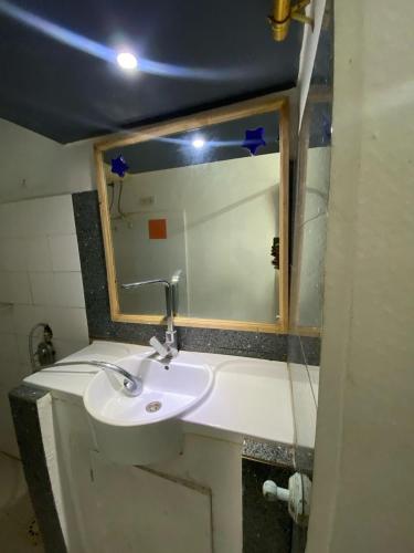 a bathroom with a sink and a mirror at Ndiamala in Darou Rhamane
