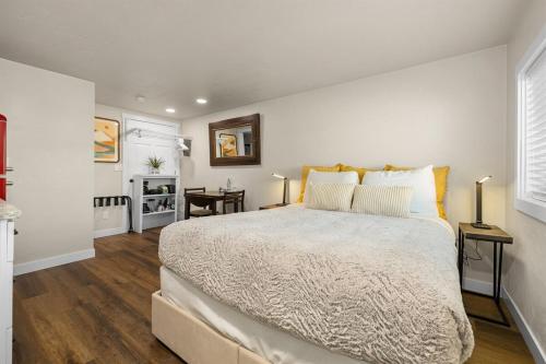 a bedroom with a large bed and two tables at Eagle Nest Retreat - Modern Studio in Eagle in Eagle