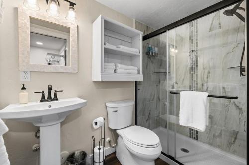 a bathroom with a toilet and a sink and a shower at Eagle Nest Retreat - Modern Studio in Eagle in Eagle