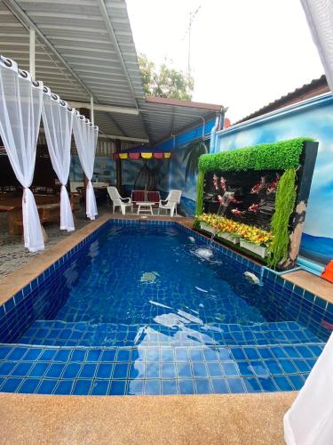 a pool at a resort with a fish tank at Pool Smile Villa in Bangsaen
