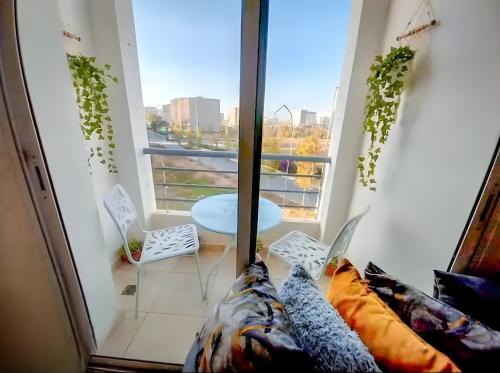 a living room with a table and a window at Rabat-Salé Big Apartment with parking near Airport in Sale