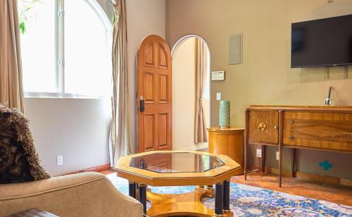 a living room with a glass table and a door at Beverly Hills Spanish in Los Angeles