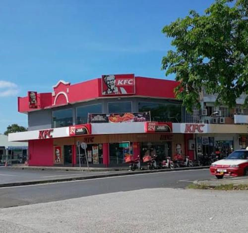 a red building on the side of a street at D'boss Homestay Sandakan in Sandakan