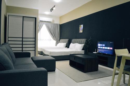 a bedroom with a bed and a couch and a tv at KLIA AIRPORT HOMESTAY in Sepang