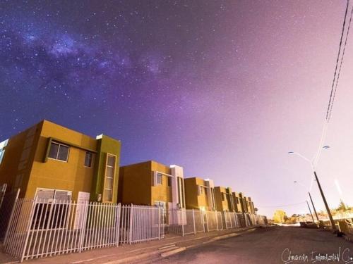 a row of buildings on a street under a starry sky at Casa TREKKING TOUR ESTANCIA EL SAUCE COQUIMBO in Coquimbo