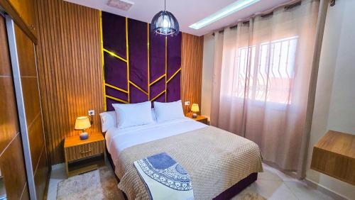 a bedroom with a large bed and a window at Elite Holiday Home - Luxury & Centric Flat in Tangier