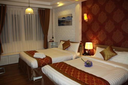 Giường trong phòng chung tại Arapang Hotel