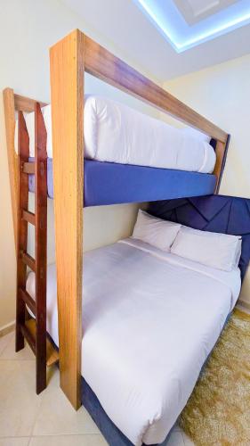 two bunk beds in a room with a ladder at Elite Holiday Home - Luxury & Centric Flat in Tangier