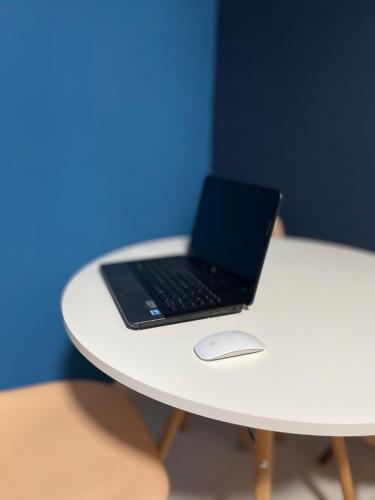 a laptop computer sitting on top of a white table at Pousada Reserva Verde in Quatro Barras