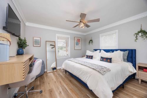 a bedroom with a blue and white bed and a desk at Lake Oliver Cottage Near Fort Benning & Downtown Columbus in Columbus