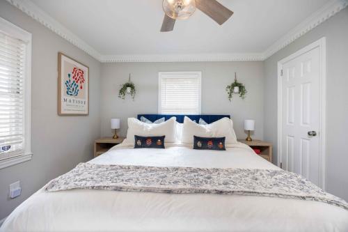 a bedroom with a large white bed with two pillows at Lake Oliver Cottage Near Fort Benning & Downtown Columbus in Columbus