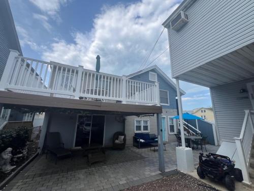a house with a white deck and a patio at 1BR Condo One Block from Sea-Balcony in Seaside Heights