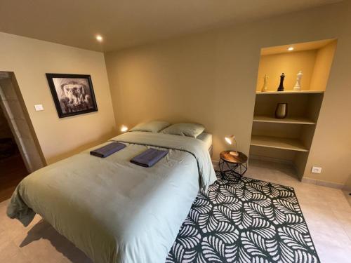 a bedroom with a large bed in a room at Gîte de Charme à Avoine avec Spa Privé et Jardin - FR-1-381-621 in Avoine