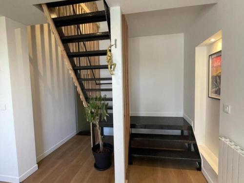 a hallway with a stairway with a stair case at Gîte de Charme à Avoine avec Spa Privé et Jardin - FR-1-381-621 in Avoine