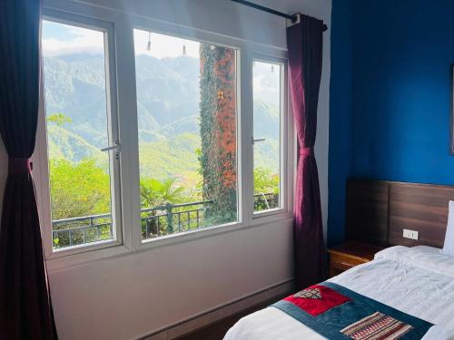 a bedroom with a window with a view of a mountain at Catcat Garden House in Sa Pa