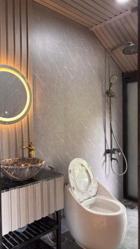 a bathroom with a sink and a bath tub at Lilys Stone Garden Bungalow in Tram de Dak Mil