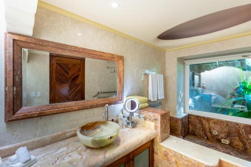 a bathroom with a sink and a mirror at P V near Colomitos Beach Boutique Hotel in Puerto Vallarta